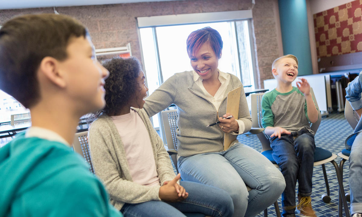 black female educator with students